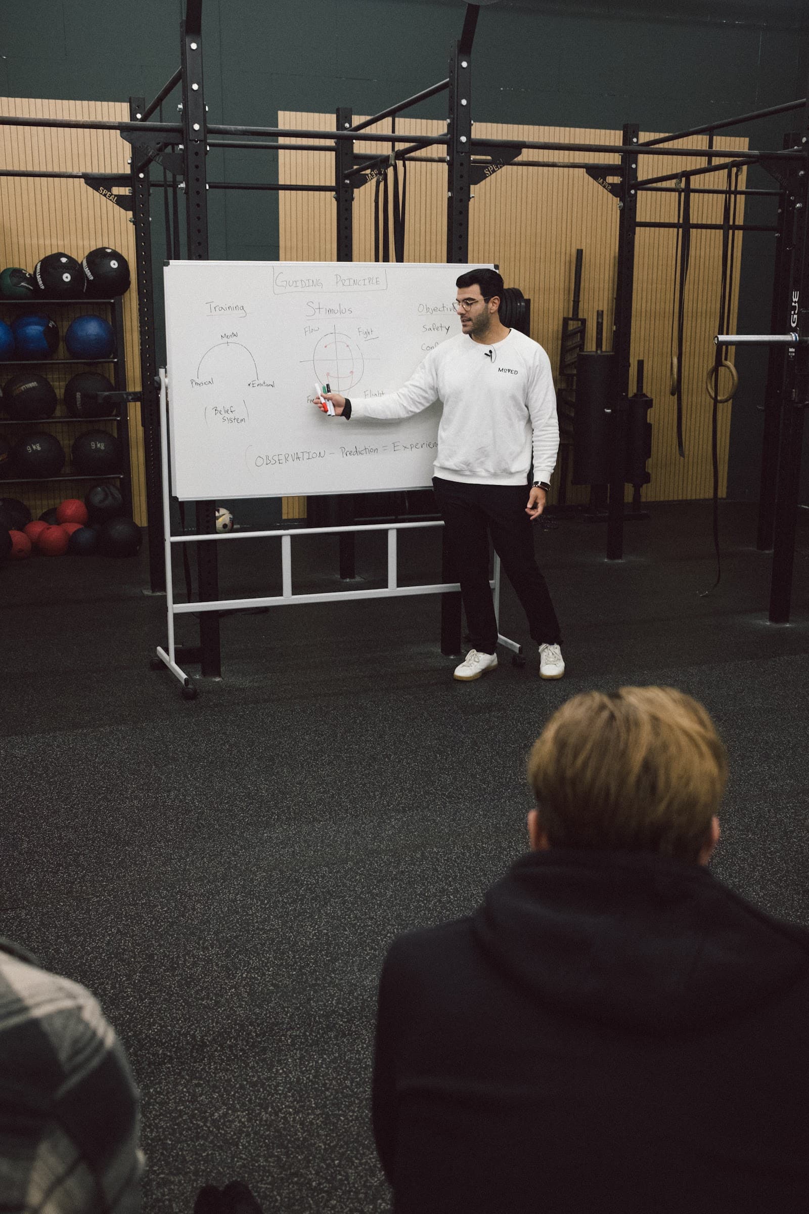 Richard Aceves teaching assessment concepts at a whiteboard